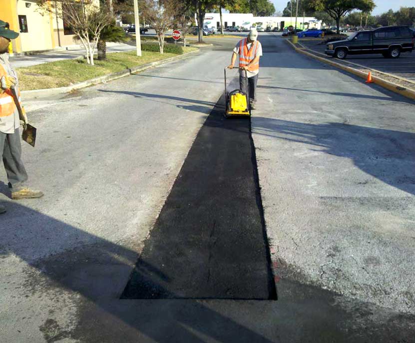 Commercial asphalt repair in Tampa showing pothole patching