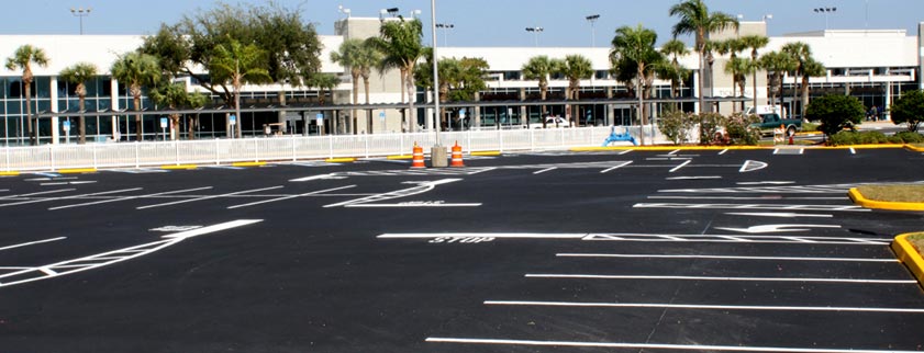 Professional parking lot striping machine marking new stalls in Tampa